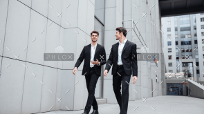 demo-attachment-922-two-businessmen-walking-and-talking-in-the-city-PMW8E26