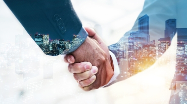 Welcome. double exposure of business man partner handshake with during sunrise and cityscape background, digital communication technology, investment, negotiation, partnership and teamwork concept