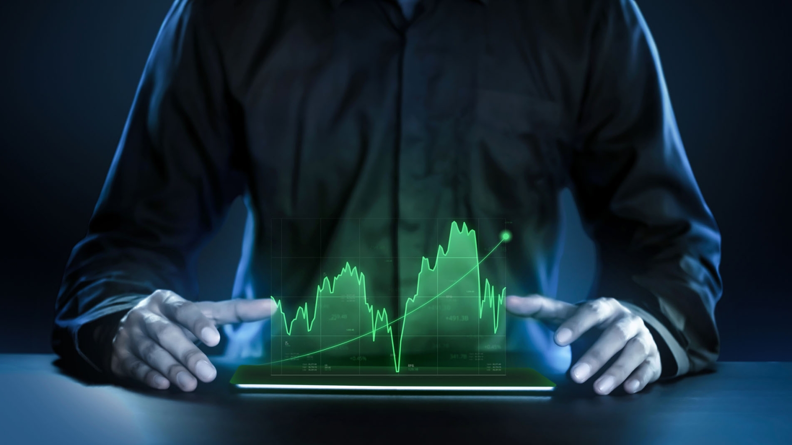 Business man showing profitable stock market holographic technology graphs in modern work background for the future. Company managers in concept planning and managing global marketing and investment.