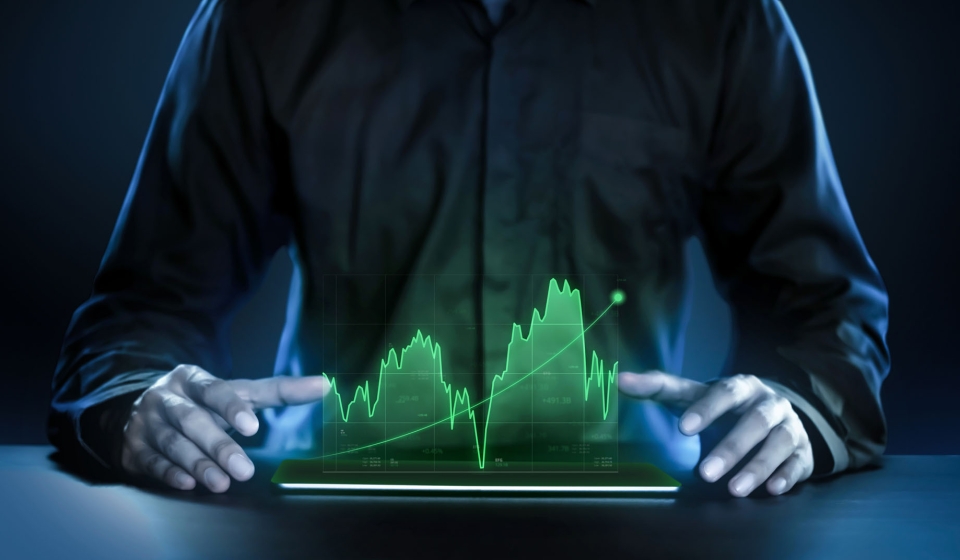 Business man showing profitable stock market holographic technology graphs in modern work background for the future. Company managers in concept planning and managing global marketing and investment.